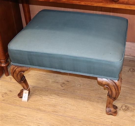 A Queen Anne style walnut stool, with green upholstery, carved cabriole legs and scrolled feet H.41cm, W.65cm